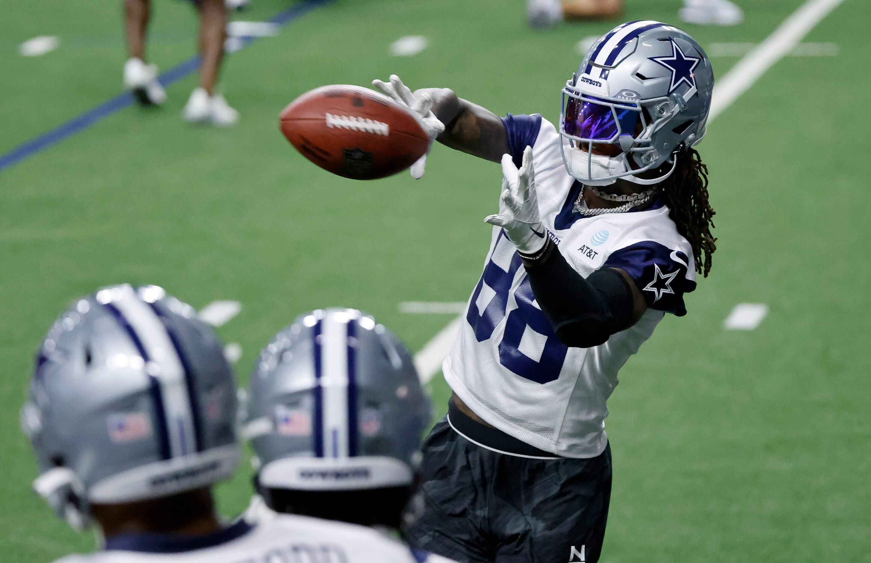 Dallas Cowboys wide receiver CeeDee Lamb (88) catches passes off the throwing machine as...