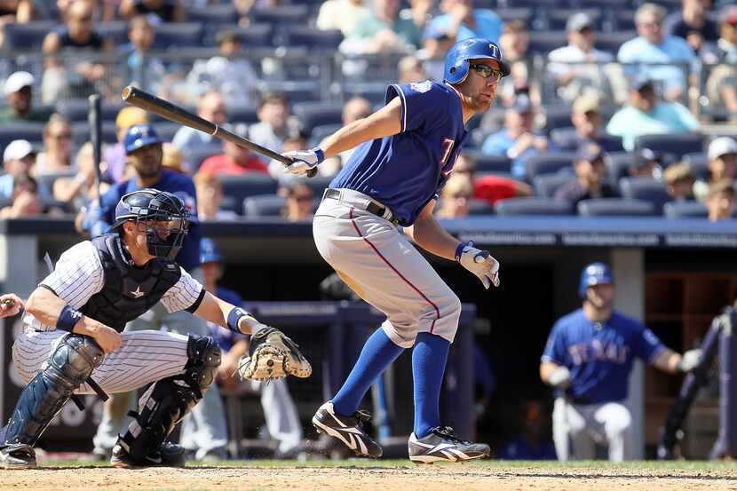 David Murphy of the Texas Rangers follows through on a game tying seventh inning RBI double...