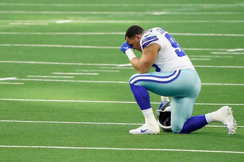 Dallas Cowboys defensive tackle Tyrone Crawford kneels in prayer before facing the...