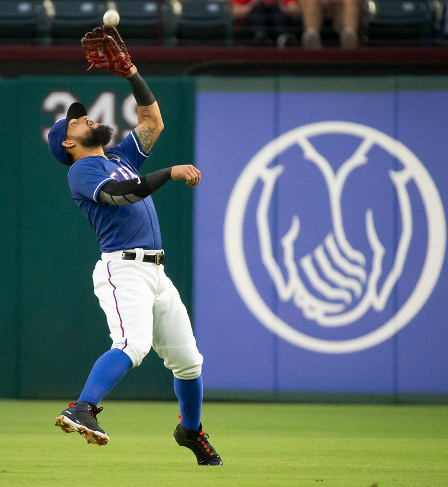 Texas Rangers second baseman Rougned Odor catches a fly ball off the bat of Houston Astros...