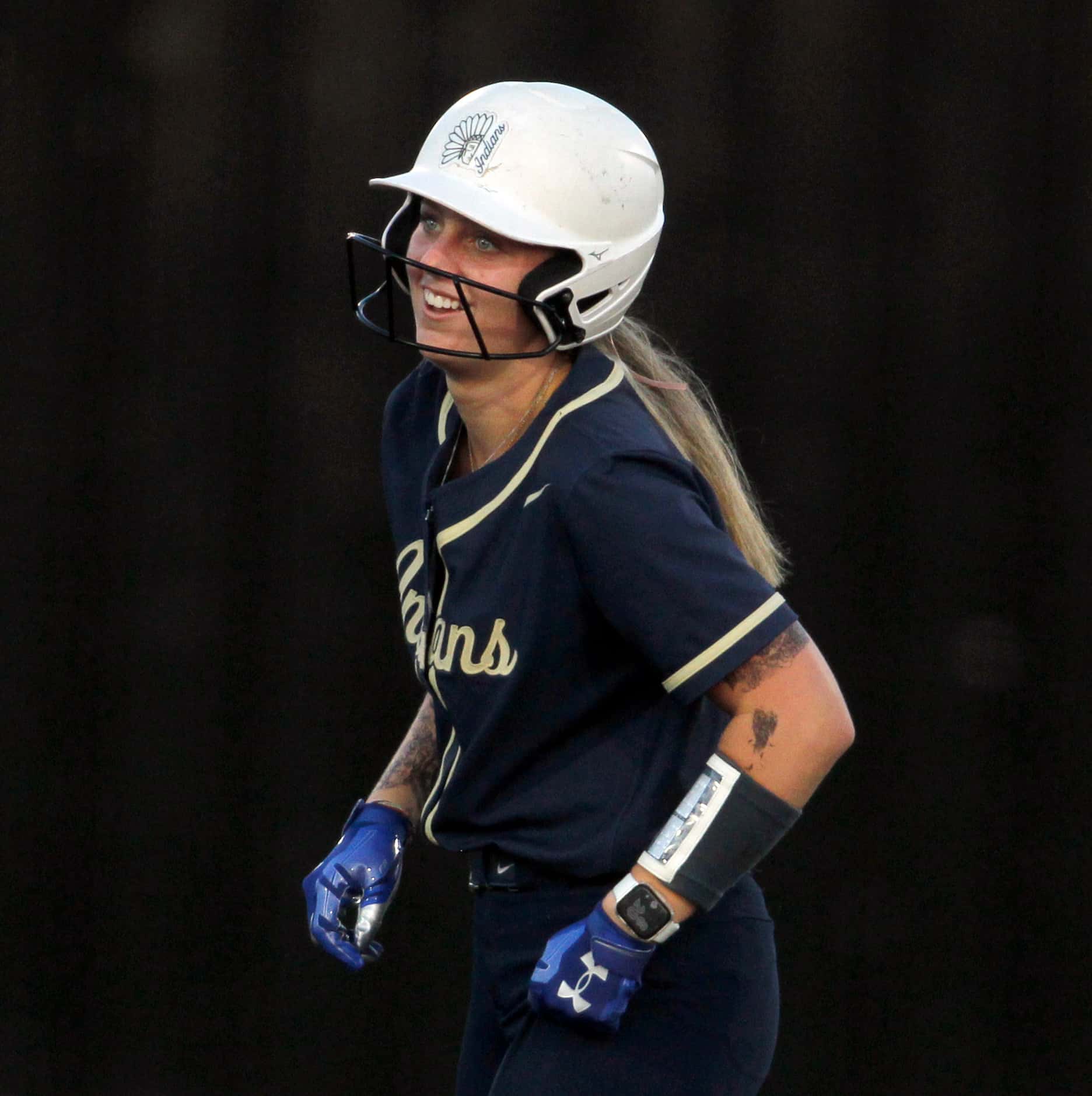 Keller first baseman Carley Genzer (15) sports a smile after hitting an RBI double during...