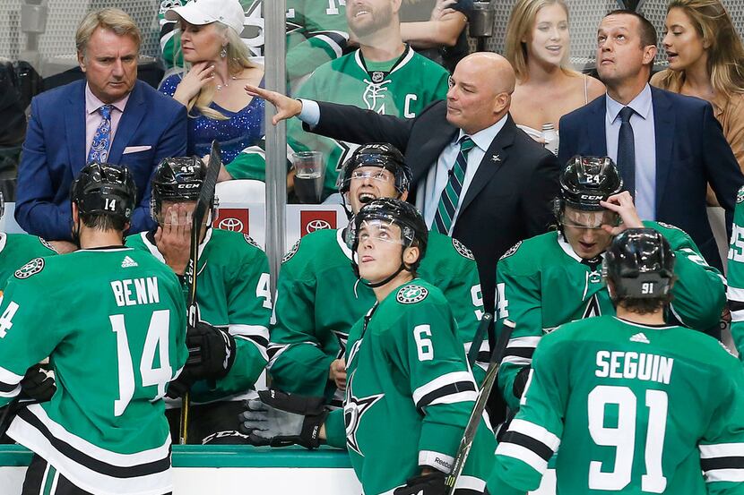 Dallas Stars head coach Jim Montgomery, center, gives instructions to his team during the...