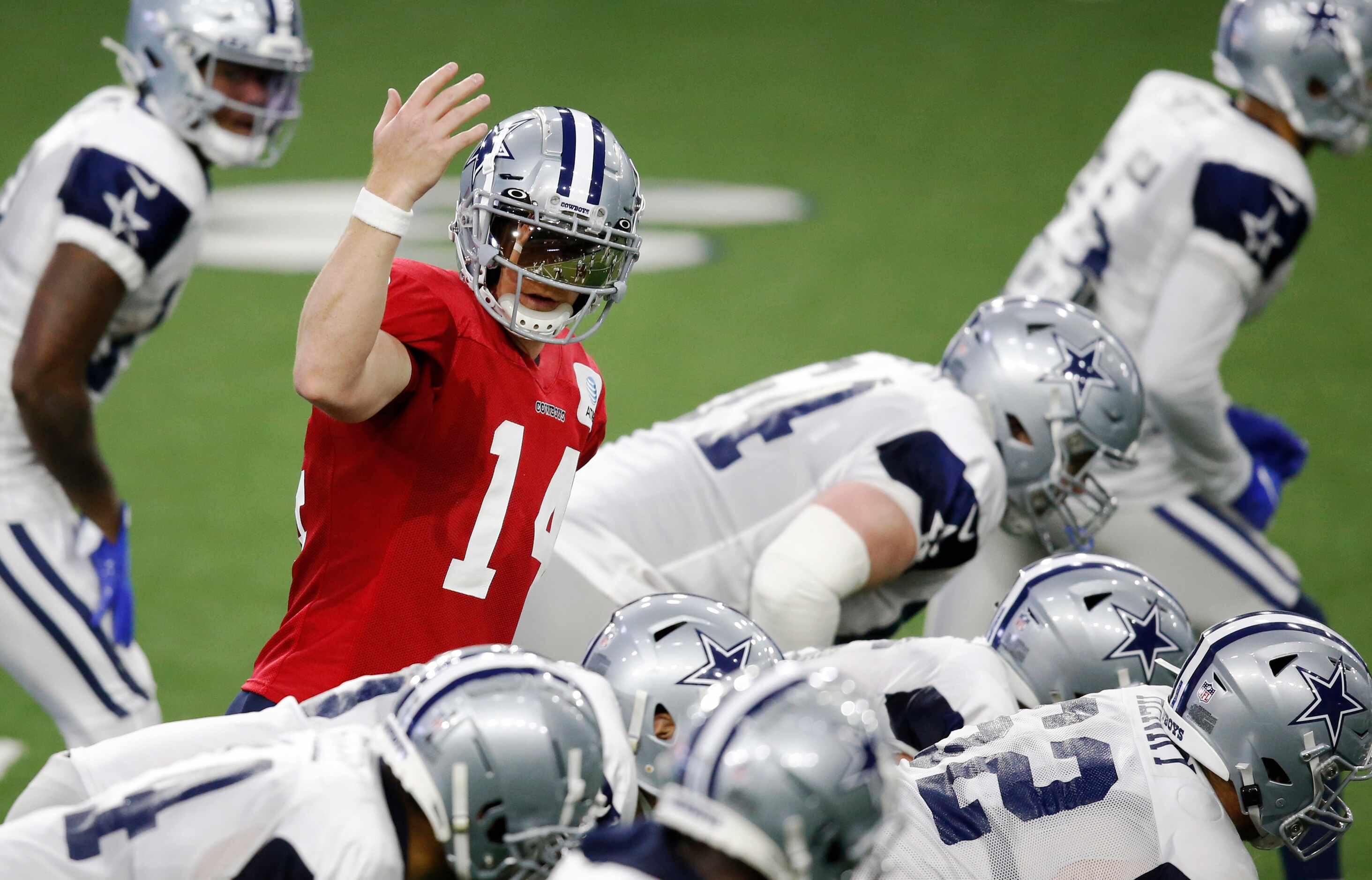 Dallas Cowboys quarterback Andy Dalton (14) signals to a teammate before the snap during...