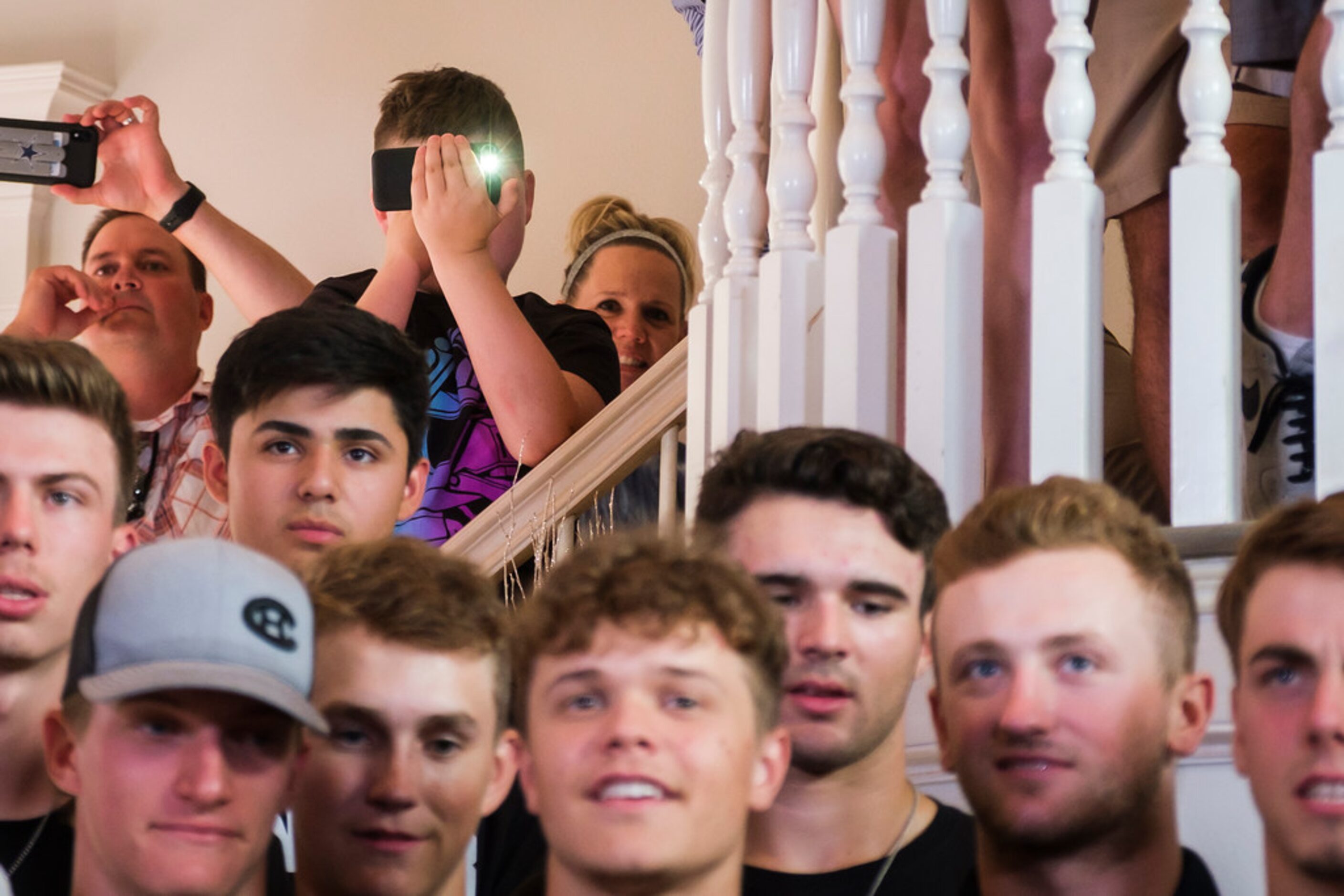 Family, friends and teammates watch coverage of the  Major League Baseball draft during a...