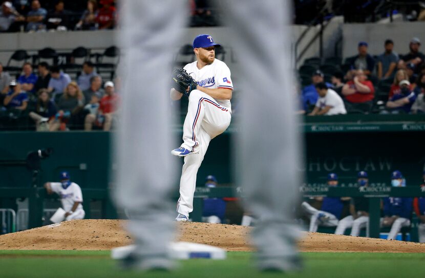 Pictured between the legs of Boston Red Sox third base coach Carlos Febles, Texas Rangers...