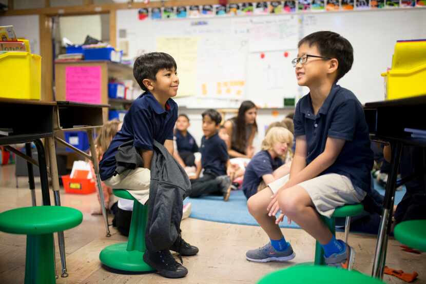 Jordan Saucedo (left), 7, and Daniel Kang, 7 sit on wobble stools donated though...