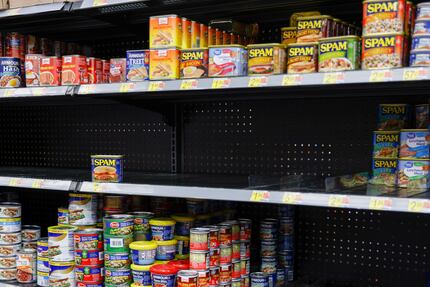 A lone can of Spam sits on a shelf at a Walmart on Retail Road in Dallas on Nov. 16.