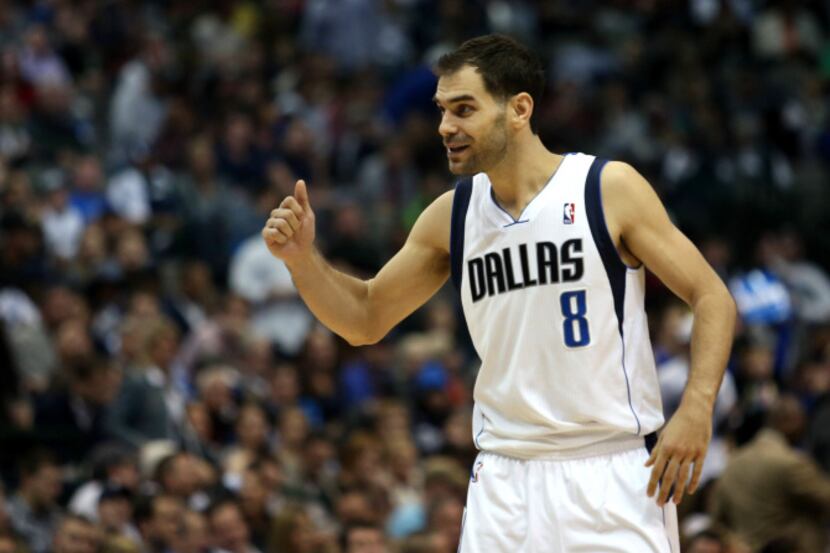 Dallas Mavericks point guard Jose Calderon (8) gives a thumbs up to his teammates after the...