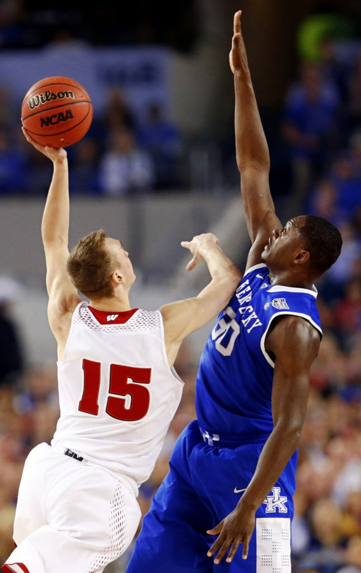 Wisconsin Badgers forward Sam Dekker (15) goes up against Kentucky Wildcats forward Julius...