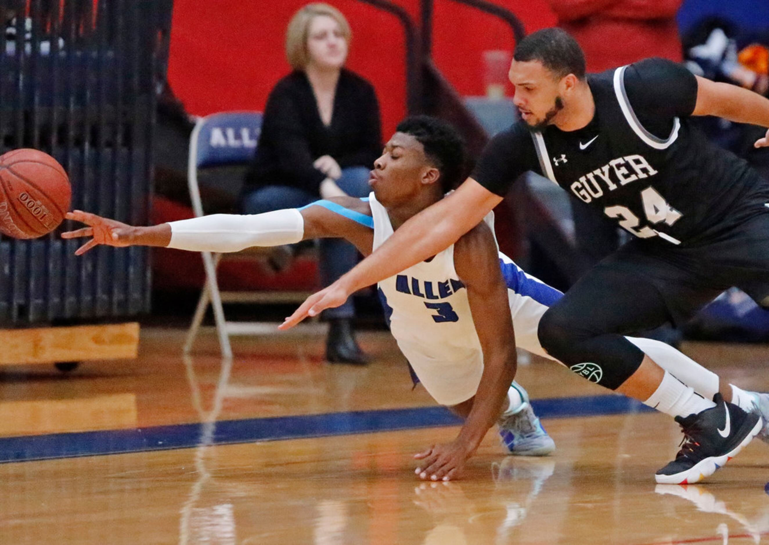 Allen High School guard Tyrone Woods (3) goes for a loose ball with Denton Guyer High School...