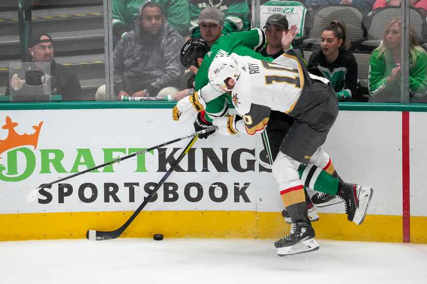 Dallas Stars left wing Jamie Benn (14) fights for the puck along the boards with Vegas...