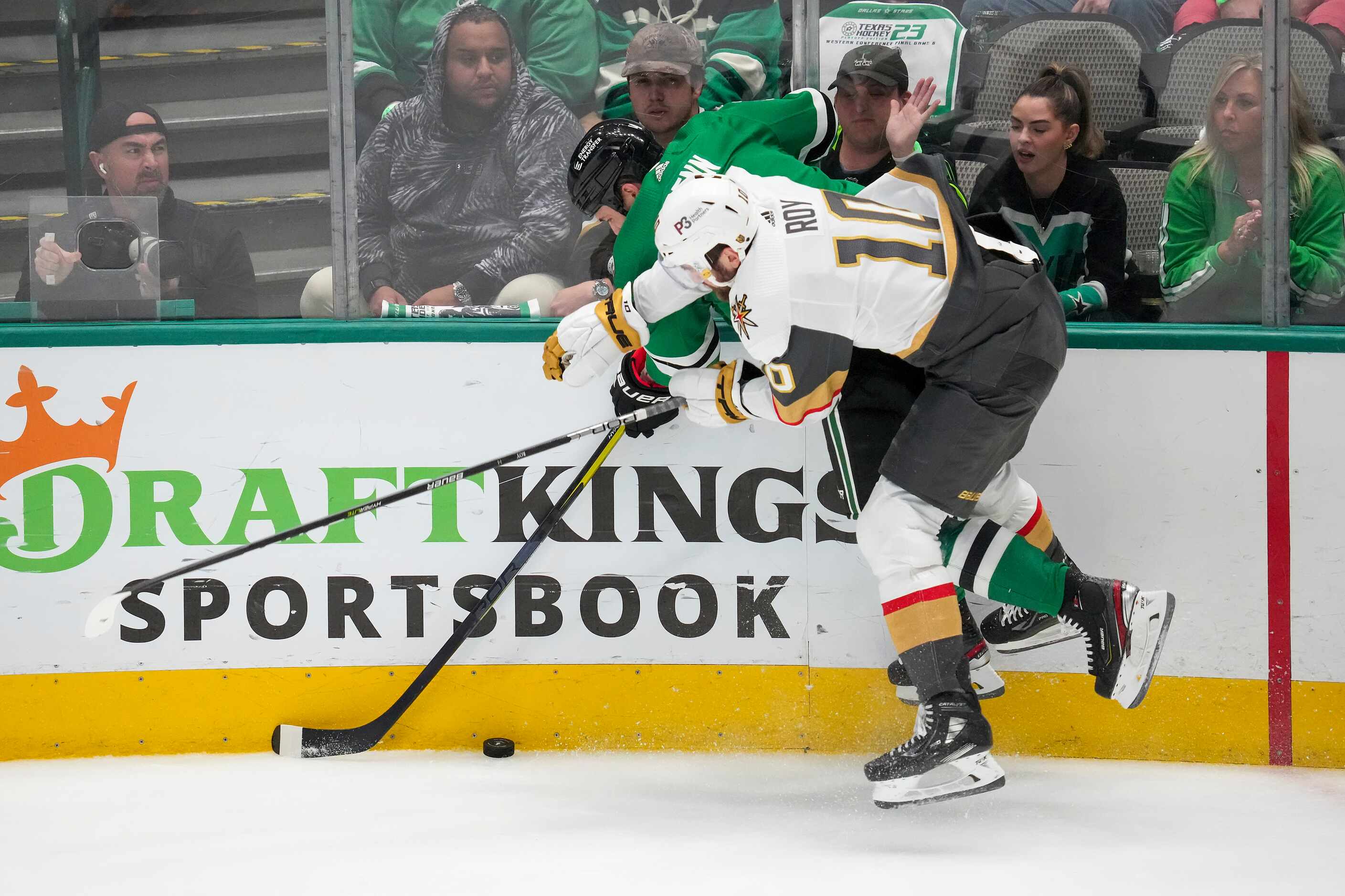 Dallas Stars left wing Jamie Benn (14) fights for the puck along the boards with Vegas...