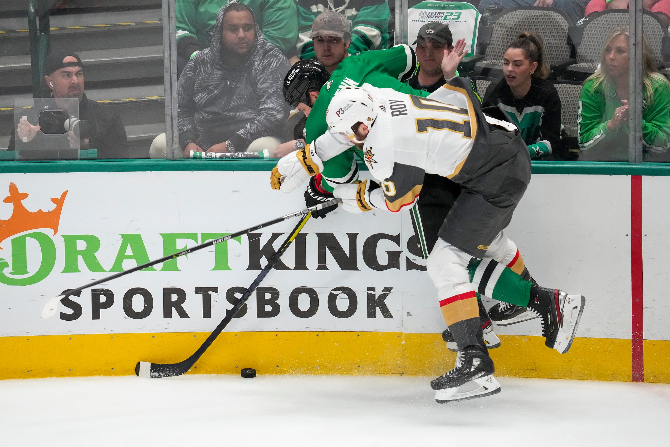 Dallas Stars left wing Jamie Benn (14) fights for the puck along the boards with Vegas...