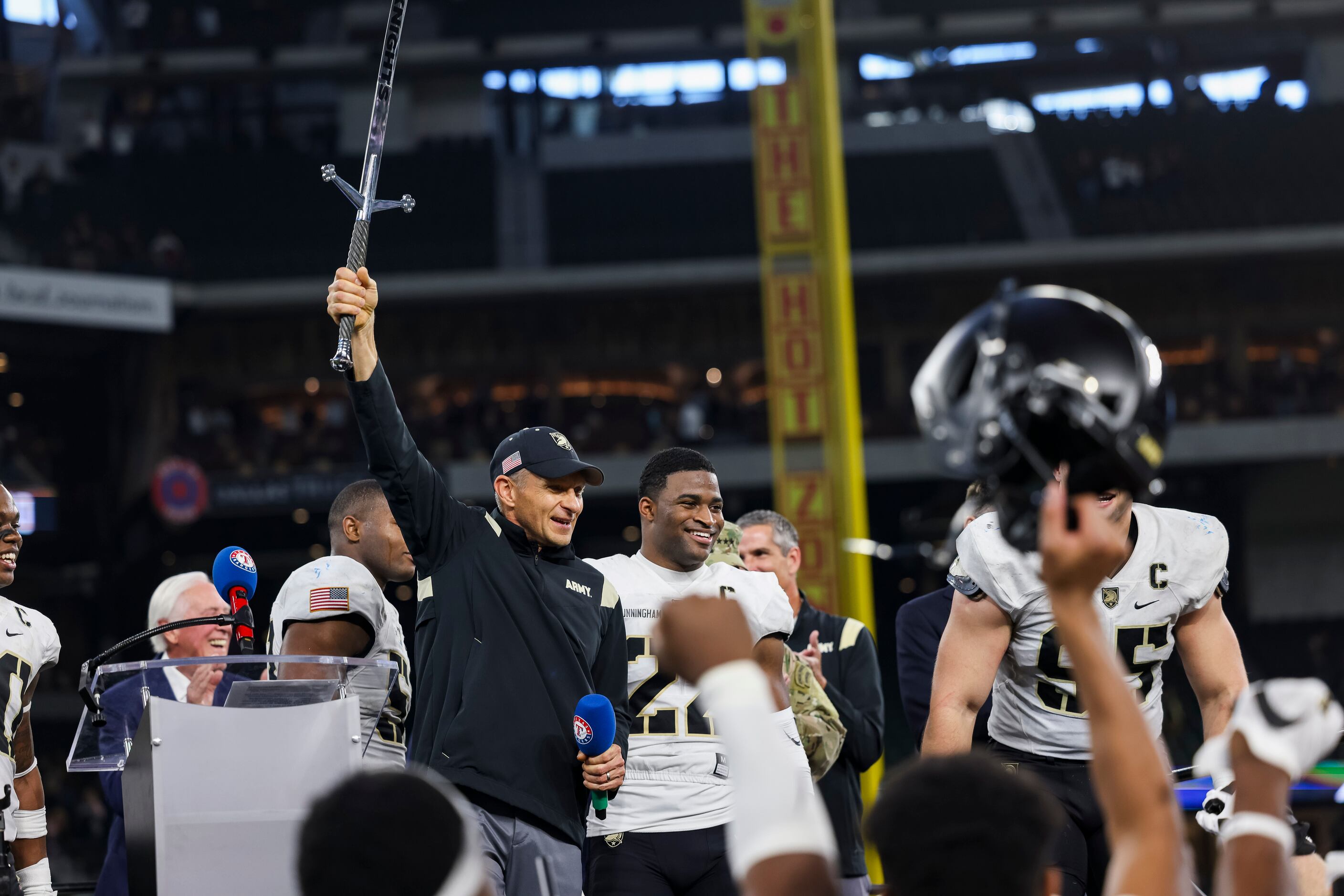 Army Black Knights head coach Jeff Monken hold the the sword after winning during overtime...