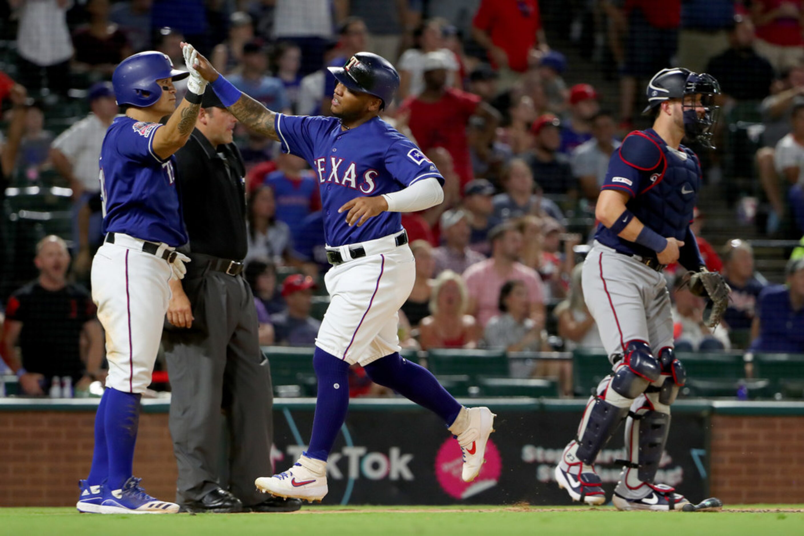 ARLINGTON, TEXAS - AUGUST 16: Willie Calhoun #5 of the Texas Rangers celebrates with...