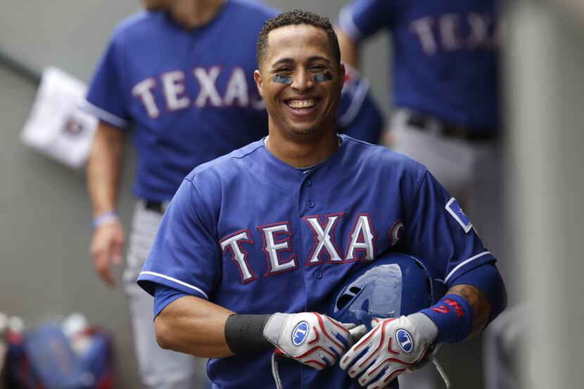 Texas Rangers' Leonys Martin smiles in the dugout after he hit a three-run home run against...