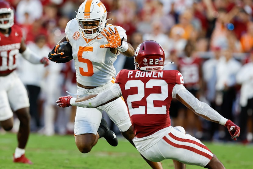 Tennessee wide receiver Bru McCoy (5) runs for a first down as he blocks a tackle from...