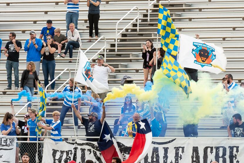 Fort Worth Vaqueros supporters group Panther City Hellfire set off flares in support of the...