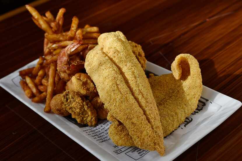A fried catfish basket with oysters, jumbo shrimp and fries from the Crab House seafood and...