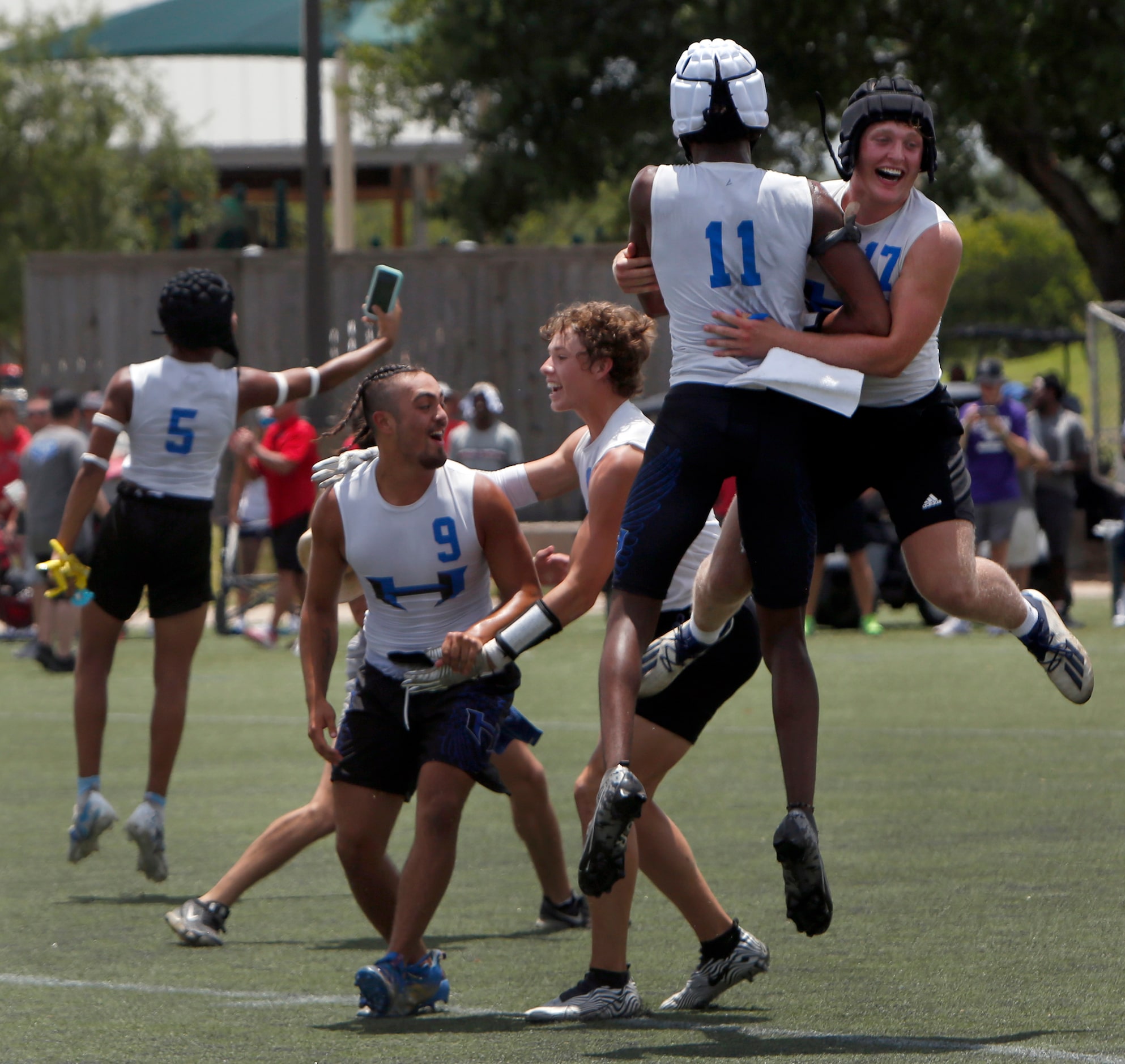 Hebron players Jack Autry (17), upper right, and Cobye Baldwin (11) jump for joy as they...