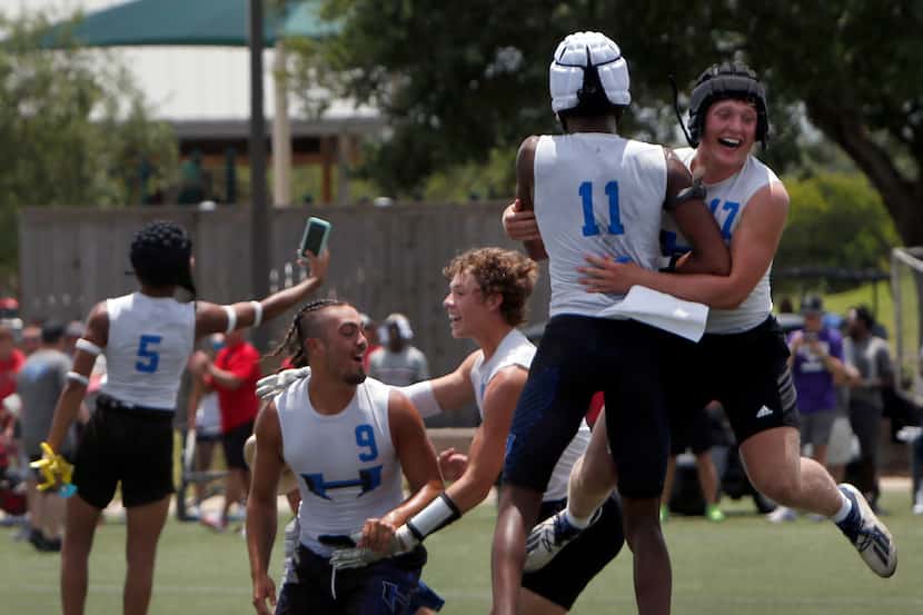 Hebron players Jack Autry (17), upper right, and Cobye Baldwin (11) jump for joy as they...