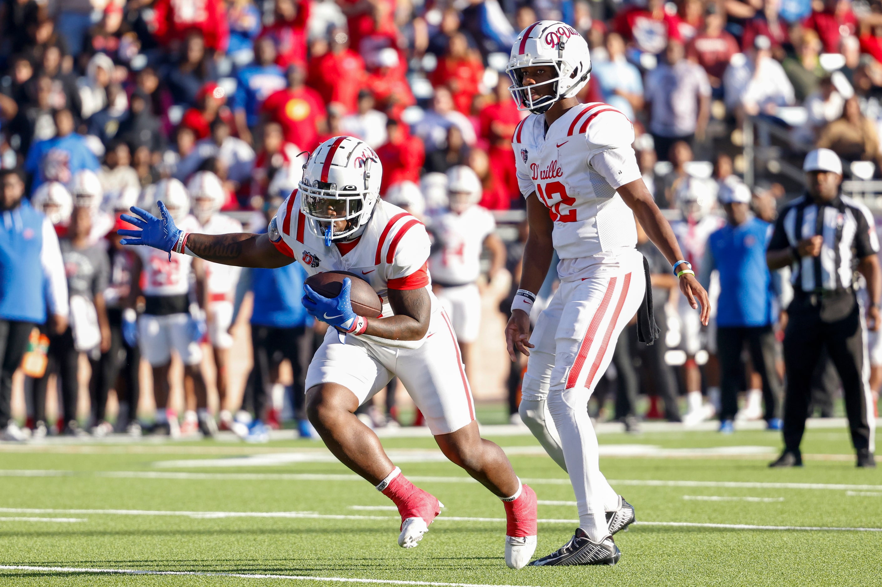 Duncanville quarterback Keelon Russell (12) hands the ball to running back JaQualon...