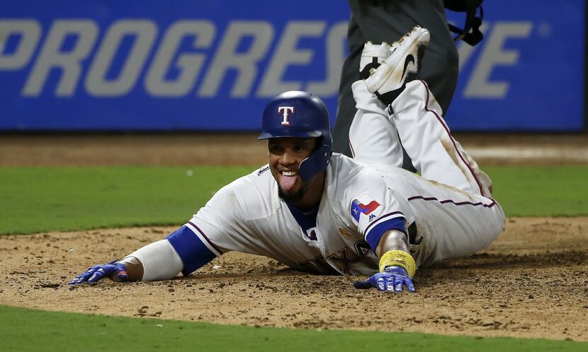 ARLINGTON, TX - SEPTEMBER 1: Carlos Gomez #14 of the Texas Rangers steals home on a wild...