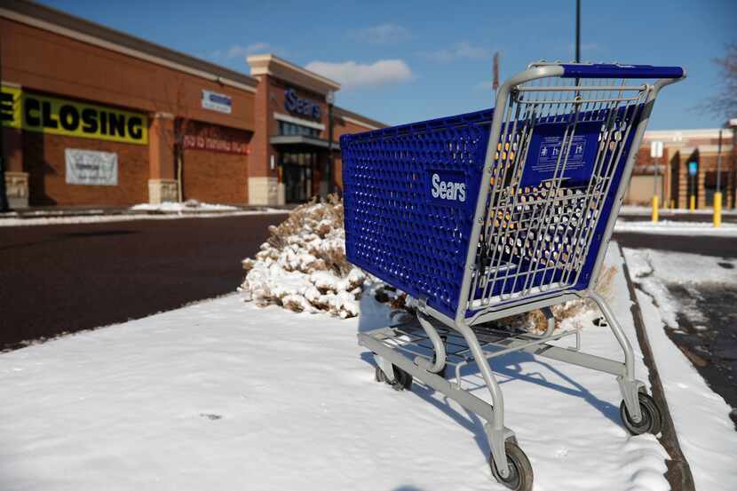 In this Jan. 1, 2019, file photo, an empty shopping cart sits outside a Sears store in the...