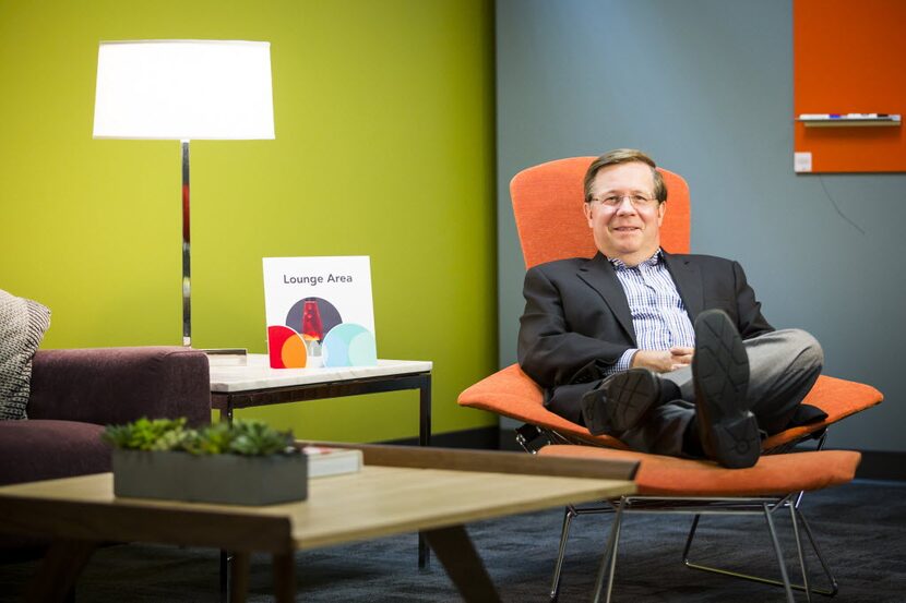 Jim Lentz, CEO of Toyota North America, stretches out in a model lounge area at Toyota's...