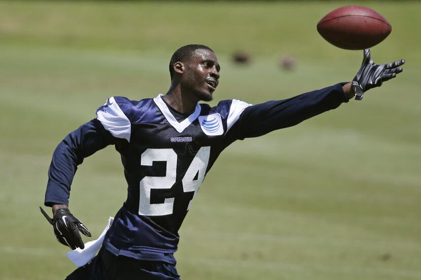 Dallas Cowboys cornerback Morris Claiborne (24) catches the ball as he works by himself...
