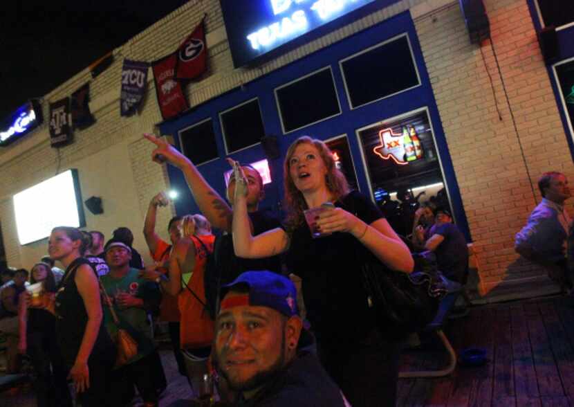Customers at Stan's Blue Note on Greenville Avenue in Dallas, Texas react to the planes...