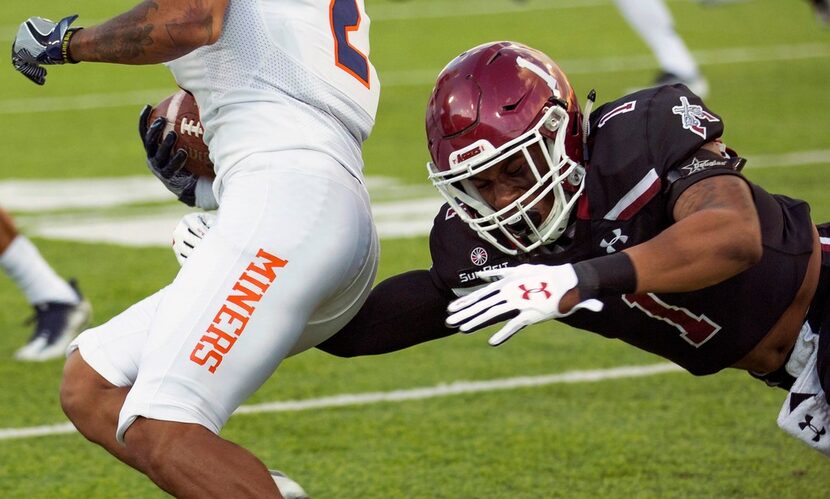 New Mexico State's Jacob Nwangwa, right, tries to take down UTEP's Terry Juniel during an...