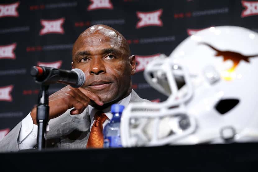 Texas head football coach Charlie Strong listens to a question from a reporter during the...
