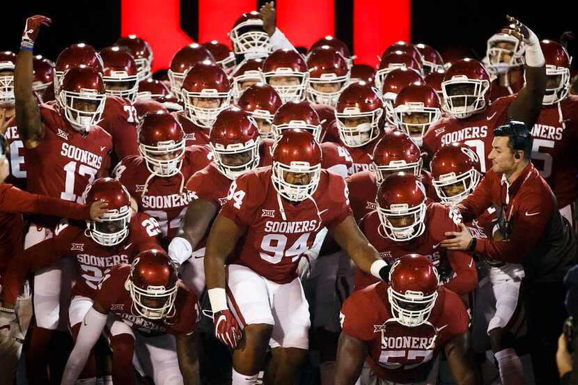 Oklahoma players take the field before an NCAA football game against TCU in Norman, Okla.,...