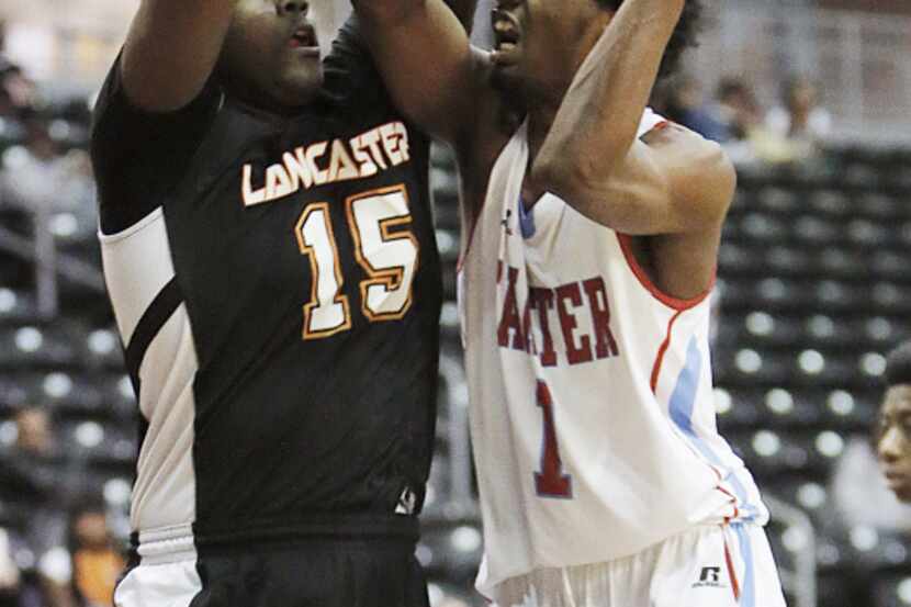 Kimball's Dondre Carter (10) attempts a layup as Lincoln's Emanuel Porter (13) defends...