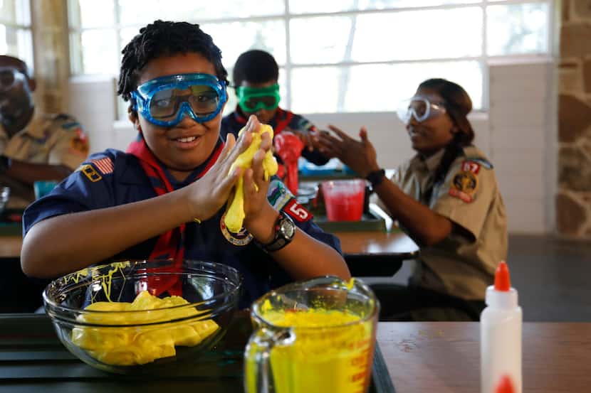 A group of young scouts participate in a science activity together.