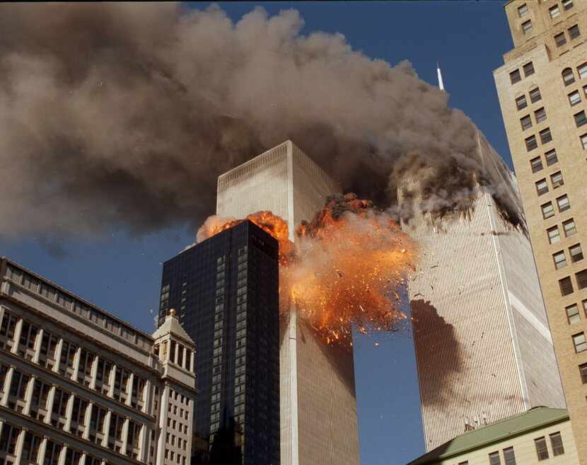 Smoke and flames streamed out of the World Trade Center towers on Sept. 11, 2001. (Chao Soi...