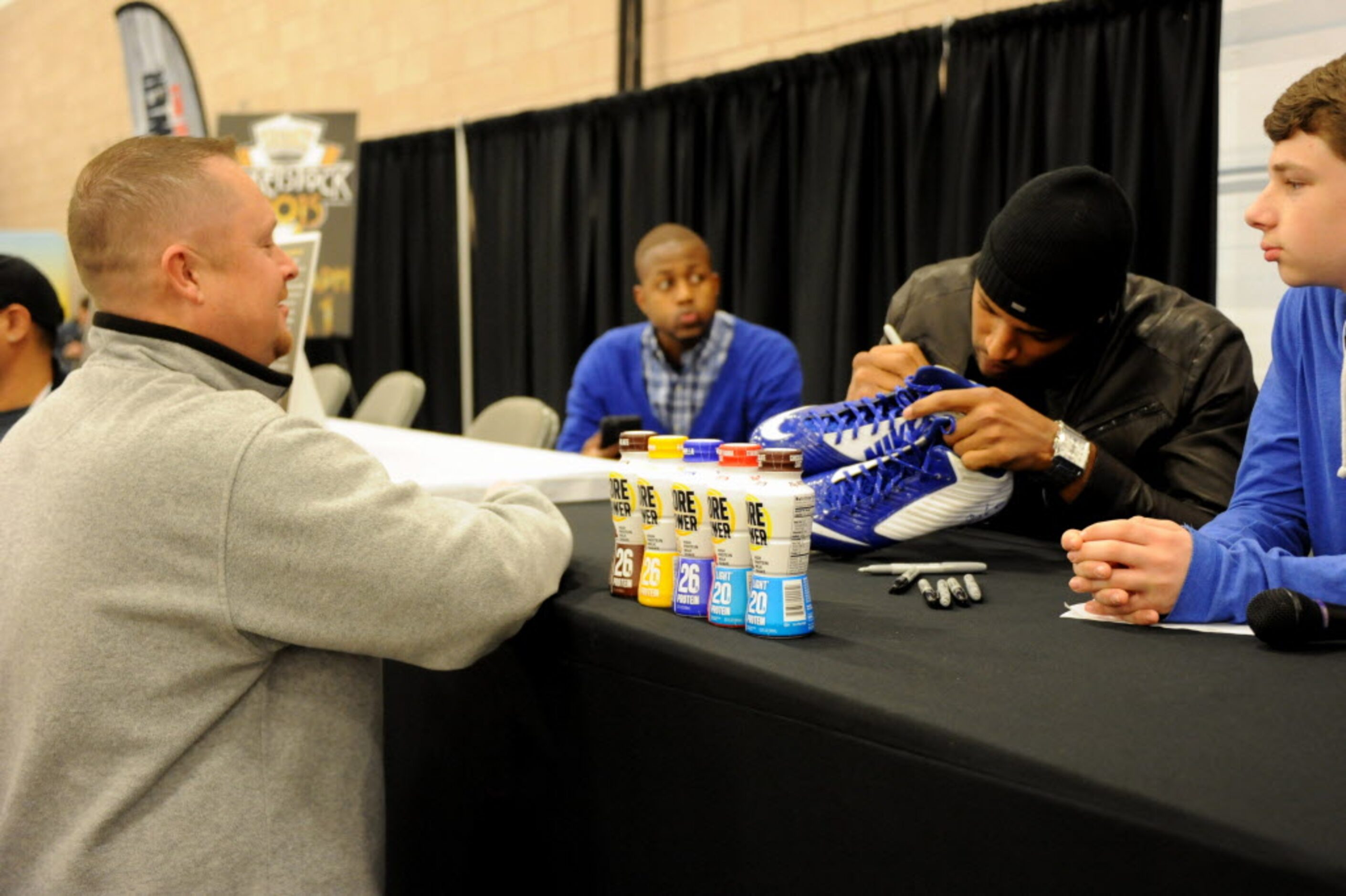 Dallas Cowboys strong safety Barry Church signs a pair of shoes for a fan at The Ticket...