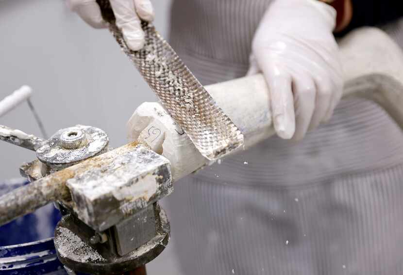 Scottish Rite orthotics and prosthetic resident Georgia Strickler files down a plaster mold...
