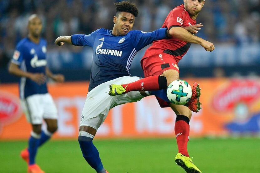 Schalke's Weston McKennie, left, and Leverkusen's Kevin Volland challenge for the ball...