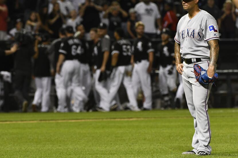 Texas Rangers relief pitcher Matt Bush reacts after the Chicago White Sox came from behind...