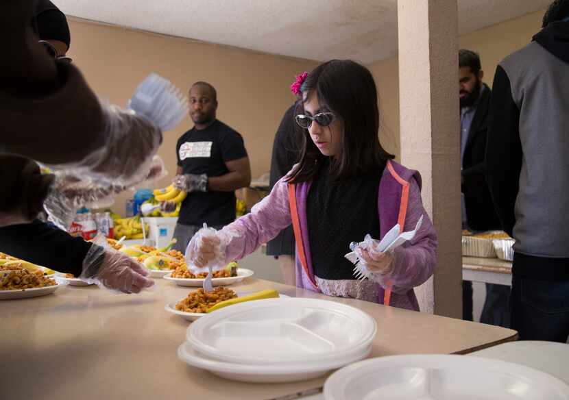 Samaah Maqsood, an 8-year-old from Richardson, helped to serve homeless people at Masjid...