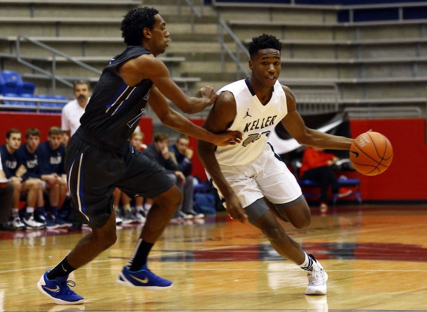 Keller's RJ Nembhard (22) drives by Plano West's Japheth Mengistu (1)  in their high school...