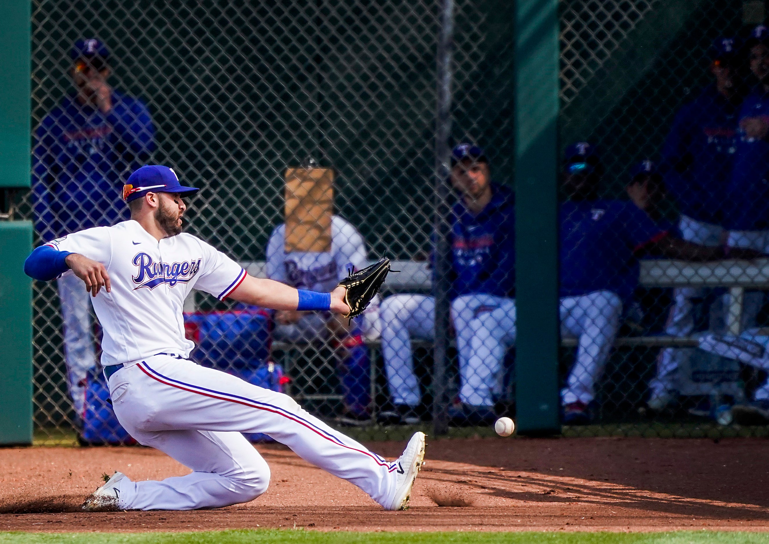 Texas Rangers outfielder Joey Gallo canÕt make a sliding catch on a foul ball off the bat of...