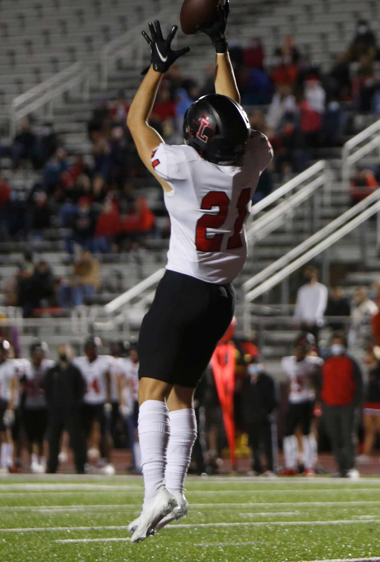 Frisco Liberty punter Mason Cacurak (21)leaps to pull in a high snap during a second quarter...