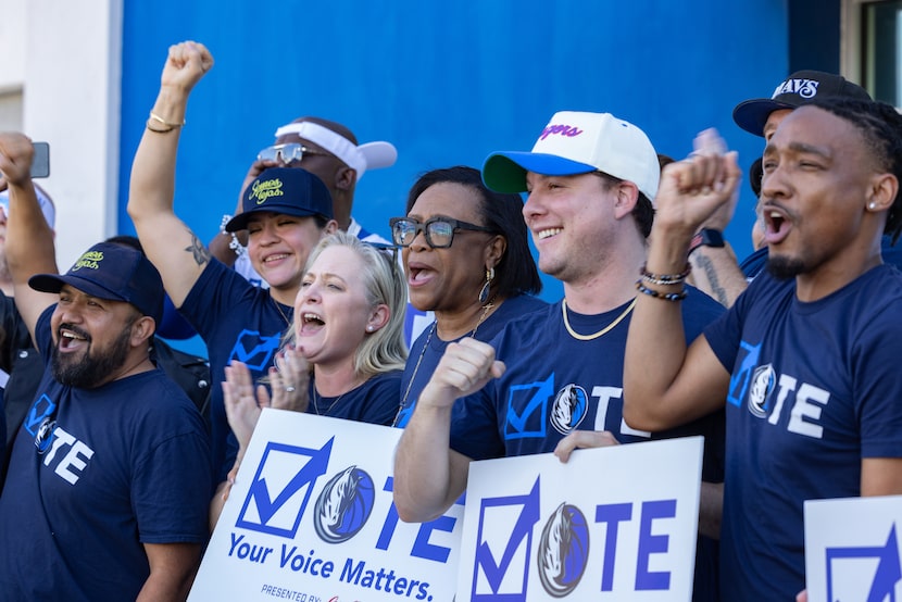 Volunteers and staff, including Mavericks chief executive officer Cynt Marshall, cheer for a...