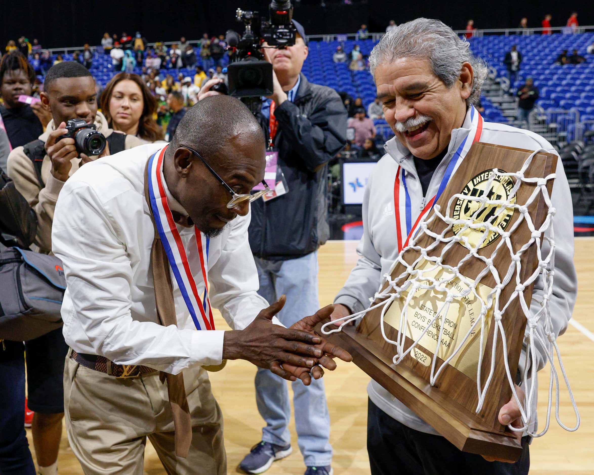 Madison head coach Damien Mobley accepts the Class 3A state championship trophy from Dallas...