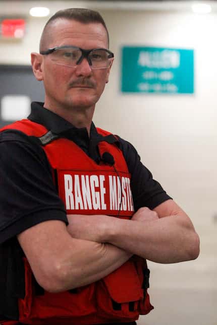 Range Master Ricky Pollan of the Allen Police Department with an Allen city-limits sign at...