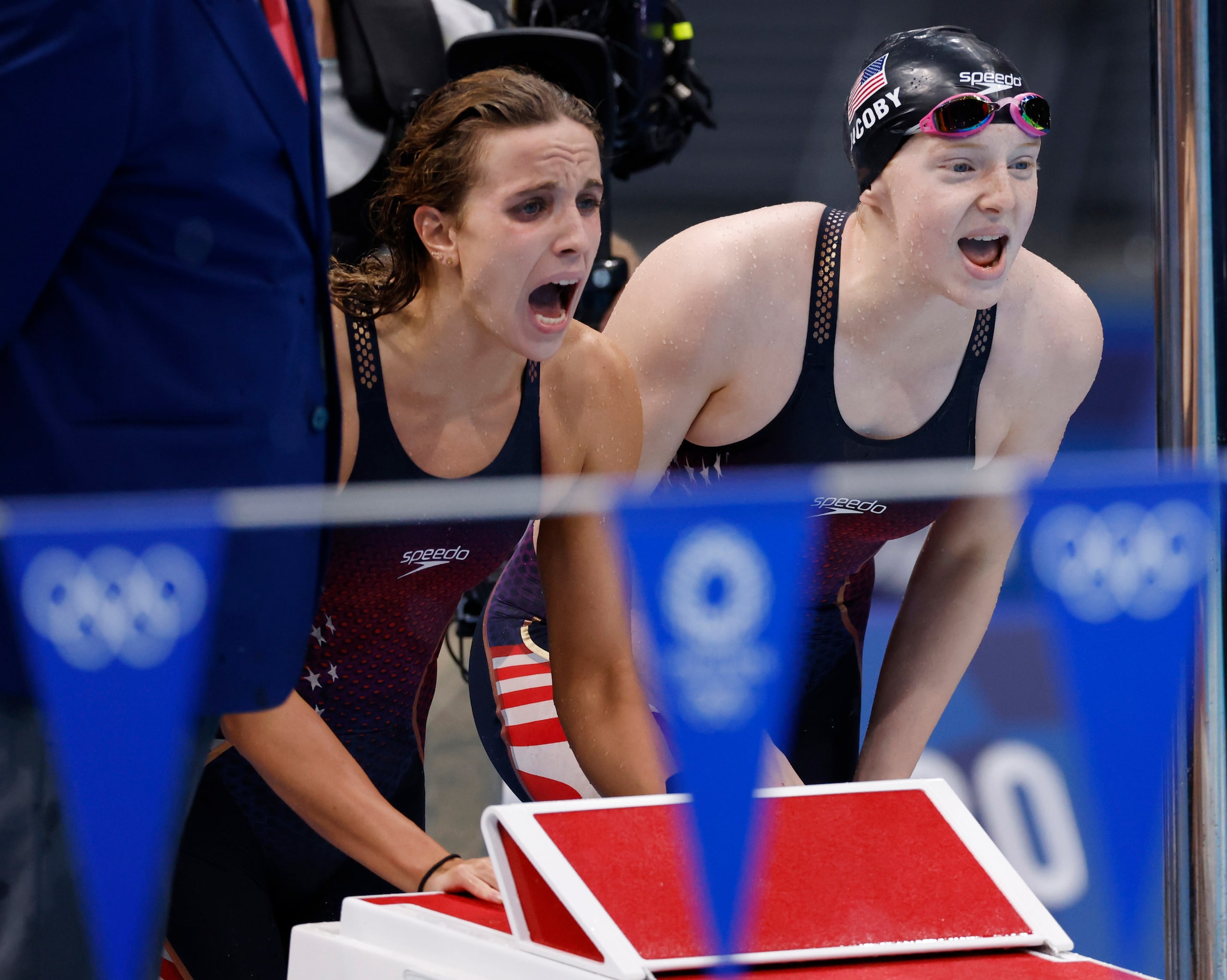 USA’s Regan Smith and Lydia Jacoby cheer on Abbey Weitzeil as she competes in the women’s...