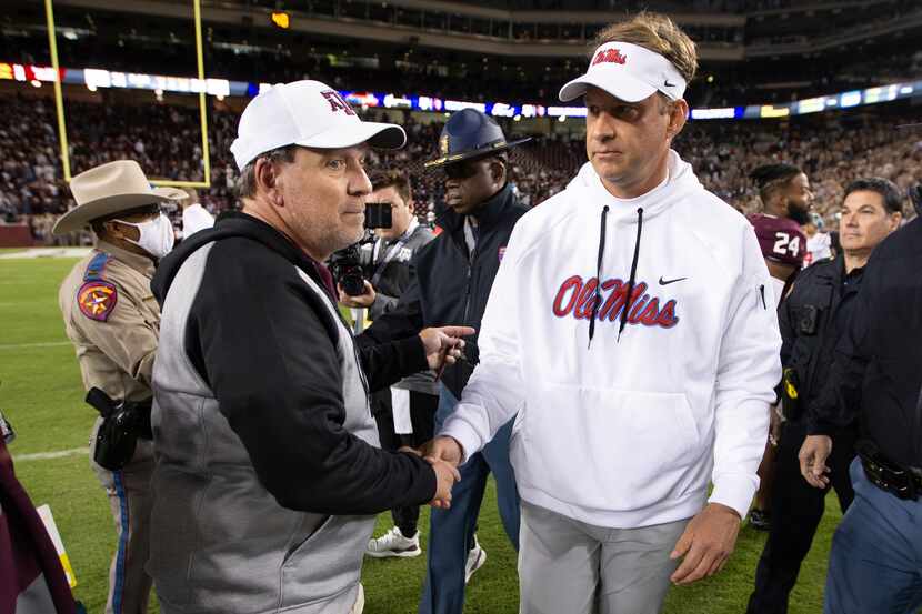 Texas A&M head coach Jimbo Fisher, left, and Mississippi head coach Lane Kiffin shake hands...